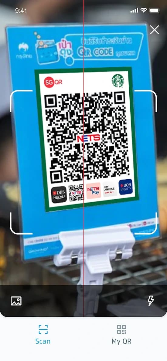 Mobile QR scanner reading a merchant payment code
